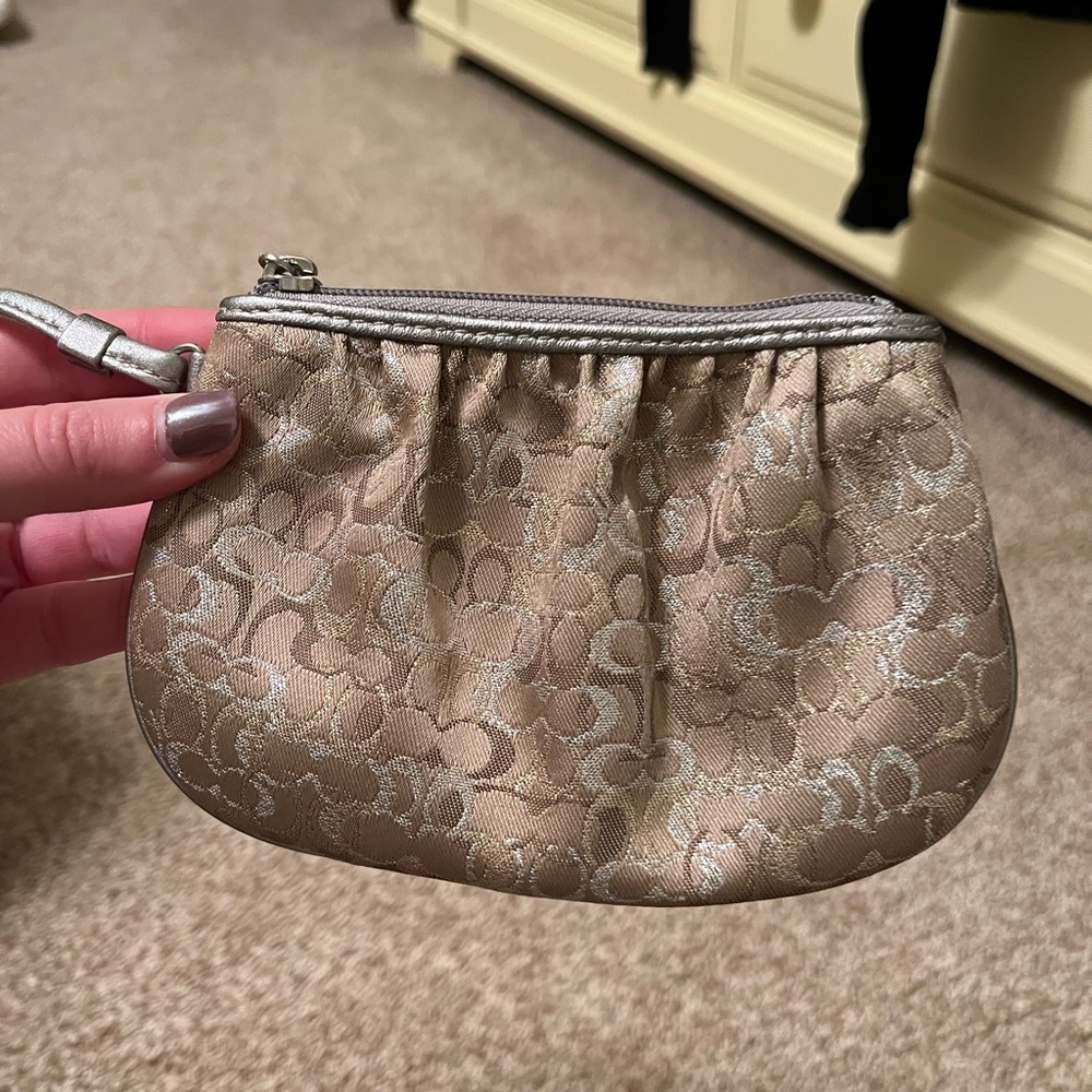 Coach tan wristlet with silver accents